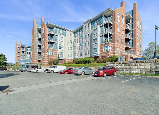 Building exterior and parking at Axis Admiral Hill Apartments in Chelsea MA