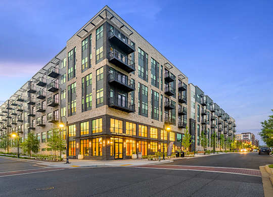 Building exterior at dusk at 333 Ellington Apartments in Gaithersburg MD