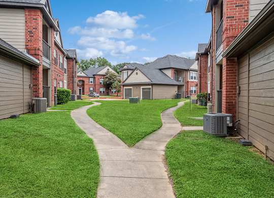 Walkway in between buildings at Hollow Creek Apartments in Conroe TX