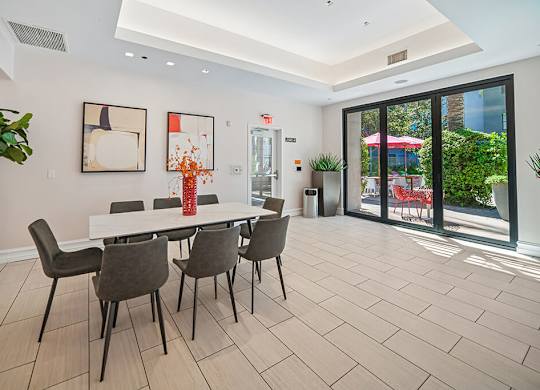 A dining room with a white table and chairs.