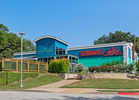 A blue building with a sign that says