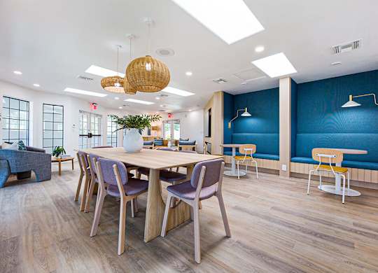 A room with a long table and chairs.