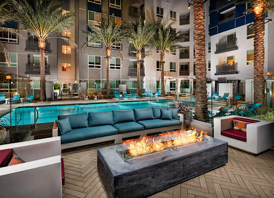 Clubroom Jive Patio Fire Table Dusk Pool Luminescence at Chroma Apartment Homes in Ca