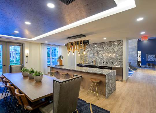 Clubroom Kitchen and Dining Table at Vero Apartments in Chelsea MA