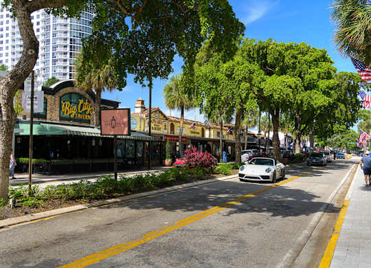 A street view with a car parked on the side of the road.