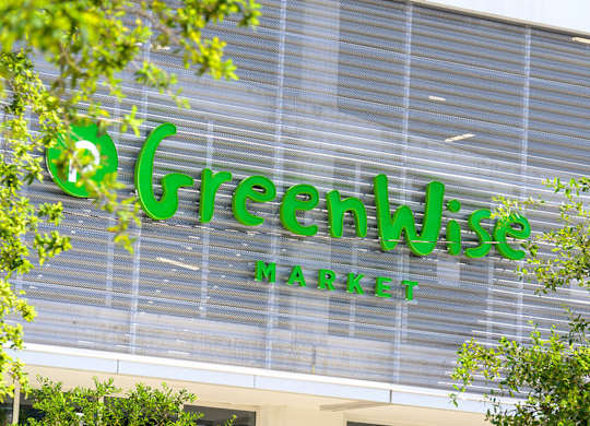 A Greenwise Market sign is displayed on a building.
