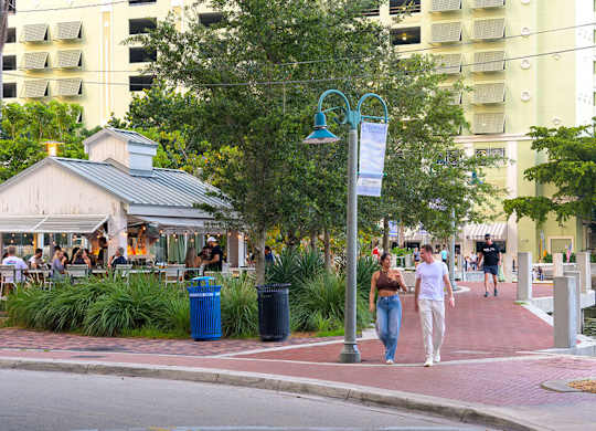 A street scene with people walking and a building in the background.