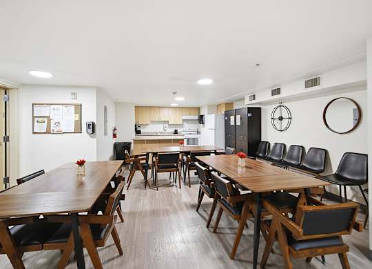 A conference room with a long table and chairs.