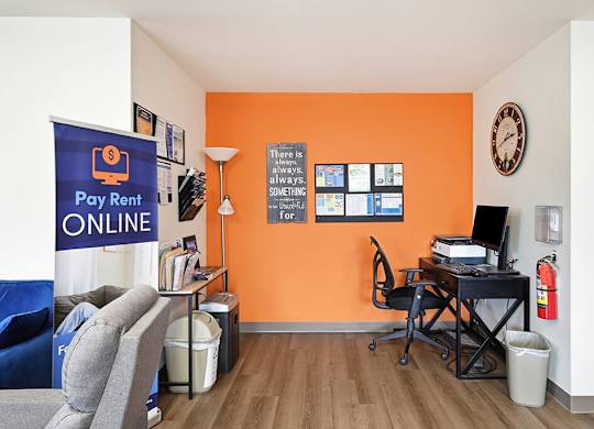 A room with orange walls has a sign that says there is always a way.