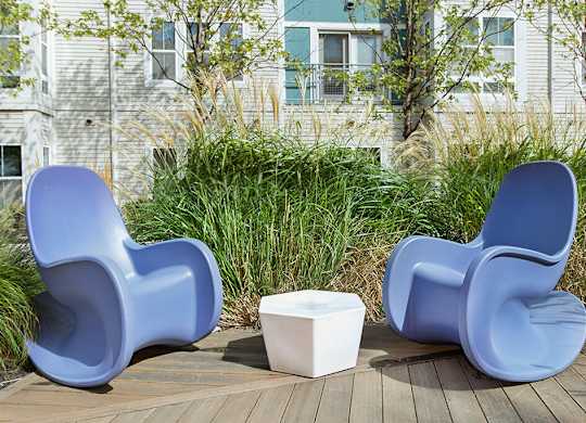 Courtyard lounge chairs at Axis Admiral Hill Apartments in Chelsea MA