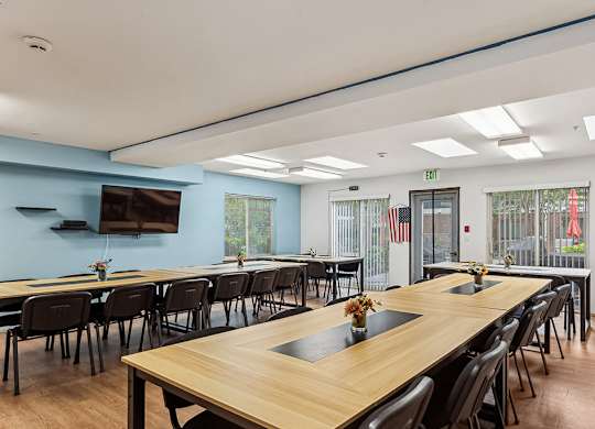 A conference room with a long table and chairs.