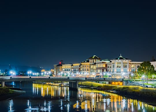 A cityscape at night with a river running through it