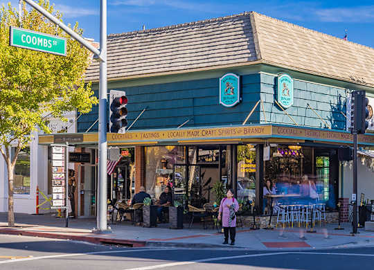 A woman is standing in front of a Coombs bar