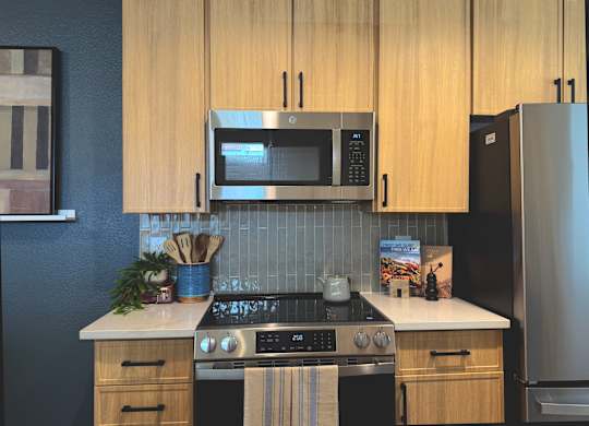 Kitchen with light wood cabinets at The Resort at Encinitas Apartments in Encinitas CA