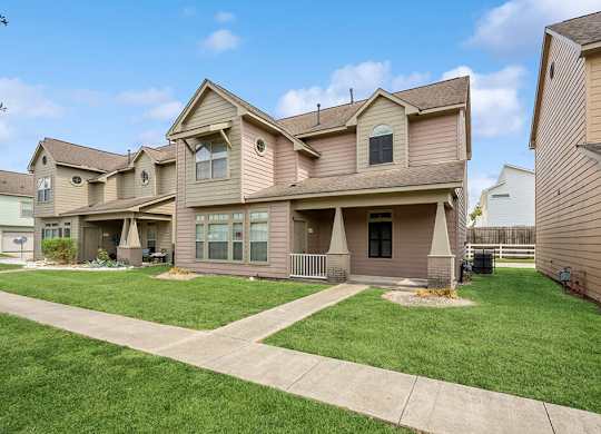 Apartments with lush landscaping at Fountains at Tidwell and The Enclave in Houston TX