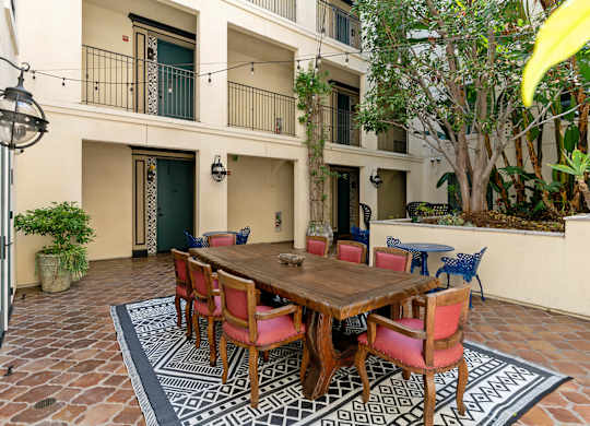 Exterior Courtyard Spanish Garden Open Air Cafe at Cardio Equipment at Candara at Hancock Park Apartments in Los Angeles CA