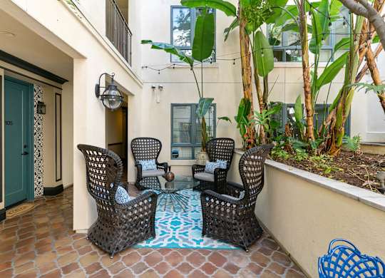 Exterior Courtyard Spanish Garden Seating Area at Cardio Equipment at Candara at Hancock Park Apartments in Los Angeles CA