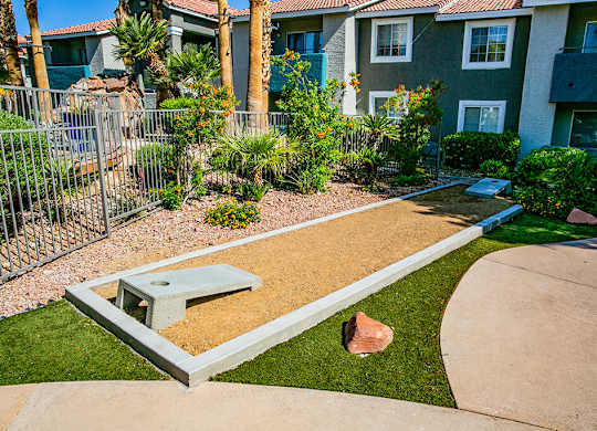a picnic table in a yard in front of a house