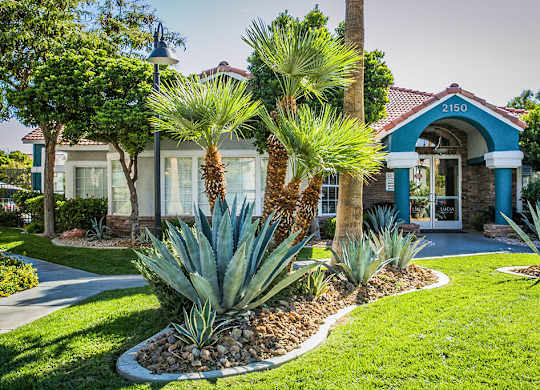 a house with trees and plants in front of it