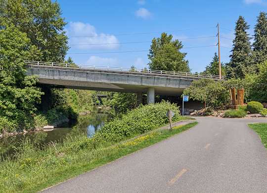 A bridge over a river with a road leading to it.