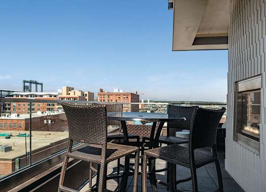 Rooftop deck with high tables at The Douglas Apartments in Denver