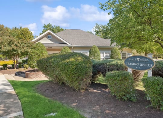 the front of a house with a leasing office sign
