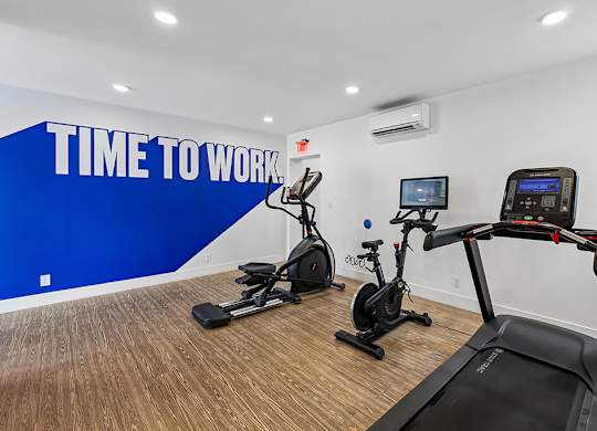 A gym room with a blue wall that says