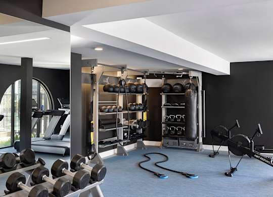 Free weights at gym at Chromatic Flats Apartments in San Diego CA