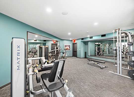 Fitness center weights at East Bend Apartments in Houston TX