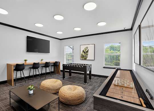 A room with a table, chairs, and a shelf with a plant on it.