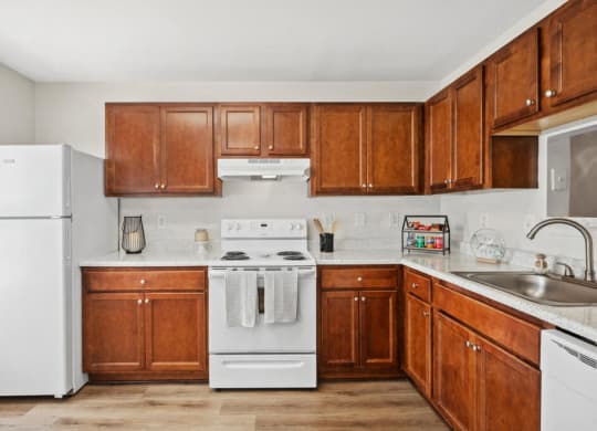 a kitchen with wooden cabinets and white appliances