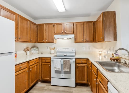 a kitchen with wooden cabinets and white appliances