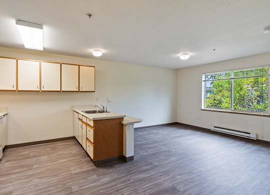 Kitchen and living room at Woodrose Senior Affordable Apartments in Bellingham WA