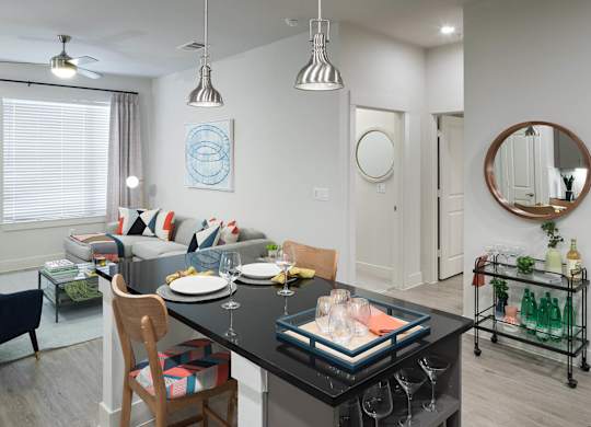 Kitchen and living area at Jada Legacy Central Apartments in Plano TX