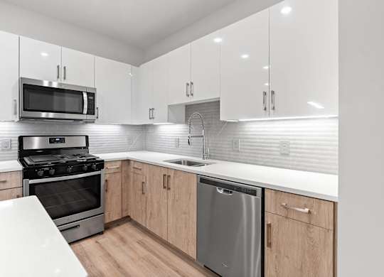 Kitchen pearl design with sleek appliances at VERO Apartments in Chelsea MA