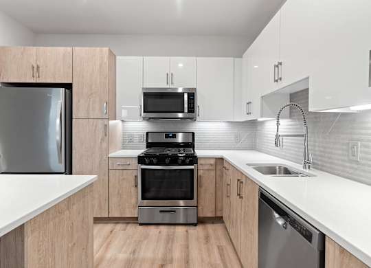 Light kitchen scheme with ligth wood cabinets at VERO Apartments in Chelsea MA
