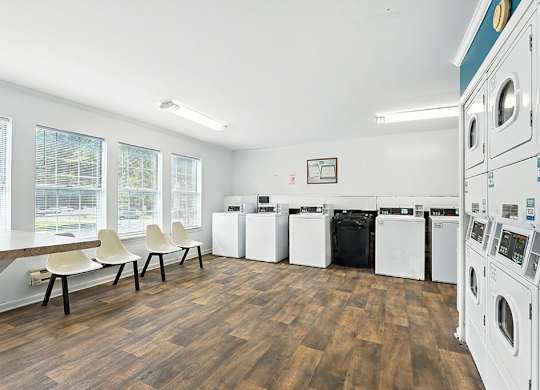 Laundry center with seating at Newport Apartment Homes in Nashville TN