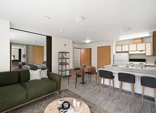 A modern living room with a green couch and a coffee table.