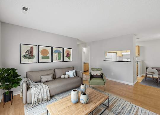 Living room with view of kitchen at Greens of Pine Glen in Durham NC