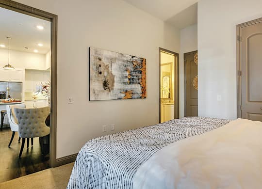 Model Bedroom with living room view at The Huntington Apartments in Plano TX
