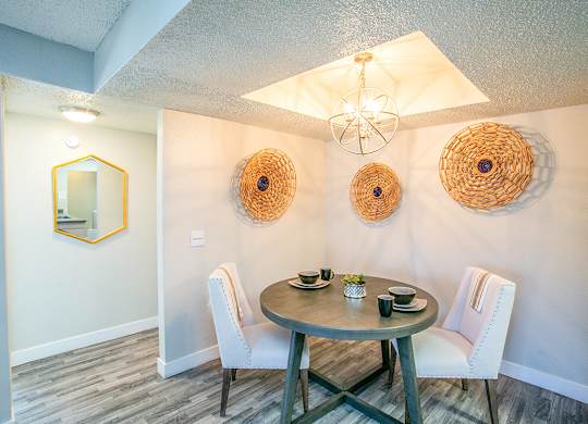 a dining room with a table and chairs
