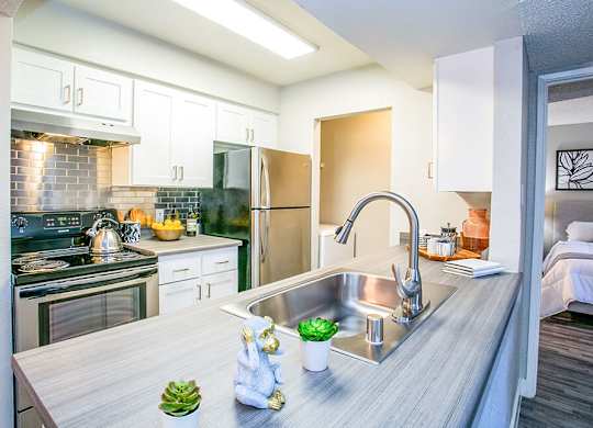 a kitchen with stainless steel appliances and a sink