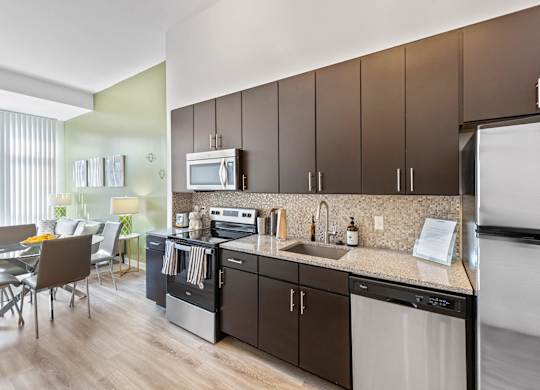 Kitchen with mocha cabinets at Bradley Braddock Road Station Apartments in Alexandria VA