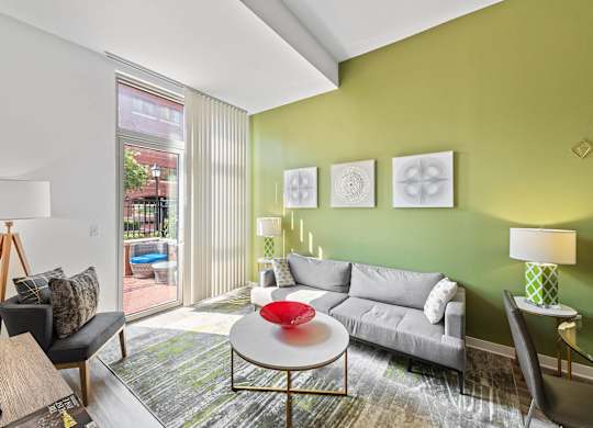 Living room with walk out balcony at Bradley Braddock Road Station Apartments in Alexandria VA