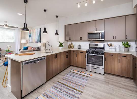 Kitchen with brown cabinets at Altitude Apartments in South San Francisco CA