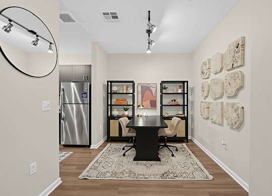 A kitchen with a fridge, a table and a chair.