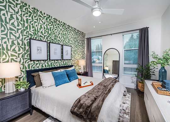 Bedroom with green accent wall at The Brynn in Kirkland WA