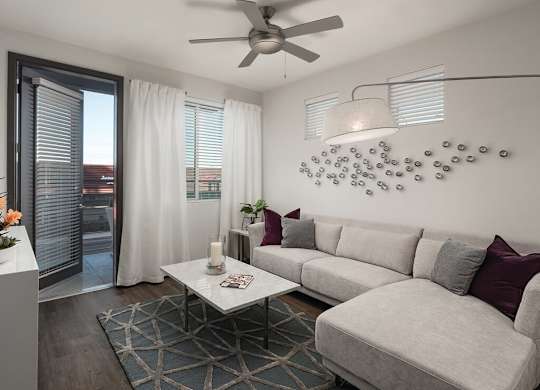 Model apartment living room with ceiling fan at Norte Town Lake Apartments in Tempe Arizona
