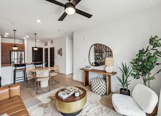 A living room with a brown leather couch and a coffee table.