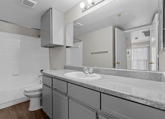 Modern bathroom with storage at Valley Ridge Apartments in Lewisville TX